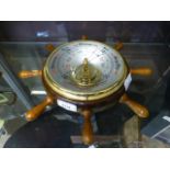 A barometer in the form of a ships wheel