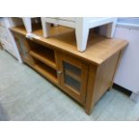 An oak TV audio cabinet with two glazed