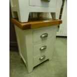 A ivory painted oak large three drawer b