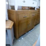 An oak sideboard with two drawers over t