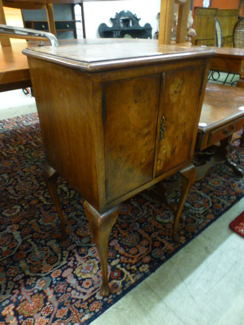 A reproduction burr walnut pot cupboard