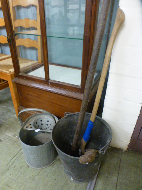 An iron stake, axe and two buckets along