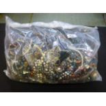 A bag of assorted costume jewellery