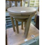 A nest of two oak three legged tables (1