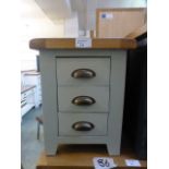 A grey painted bedside three drawer cabi