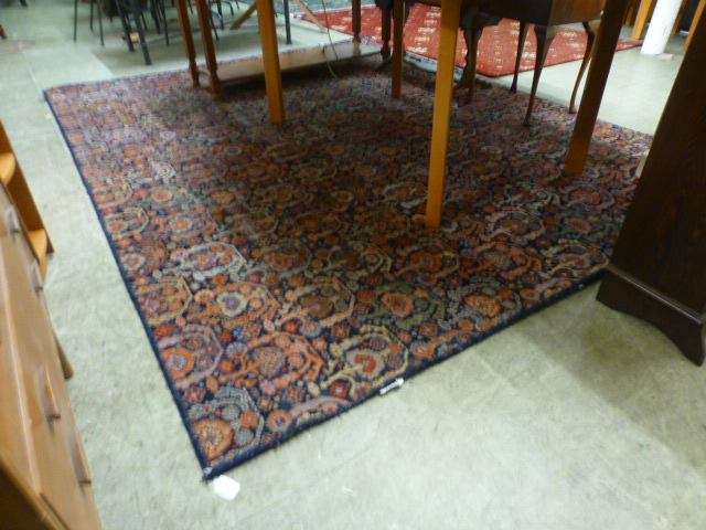 A modern blue ground rug with foliate de