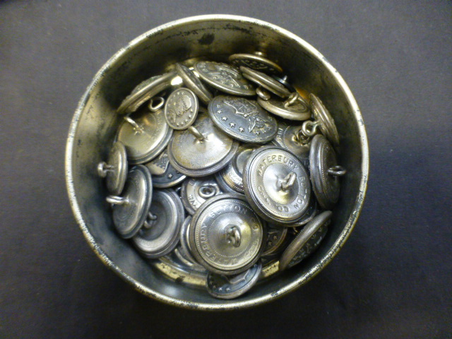 A tin of American military buttons