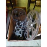 A box containing chrome taps, film reels