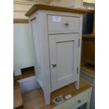 A cream painted pot style cupboard with