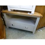 A grey painted corner TV cabinet with tw