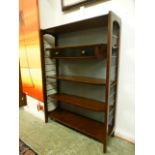 A mid-20th century open bookcase with ad