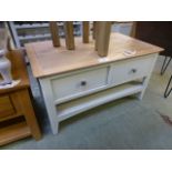 An ivory painted four drawer coffee tabl