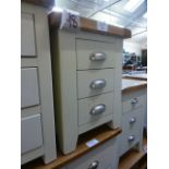 An ivory bedside three drawer cabinet (9