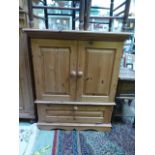 A waxed pine cabinet having two cupboard