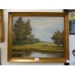 A gilt framed oil on board of cattle in