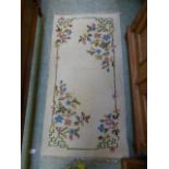 A floral cream rectangular rug