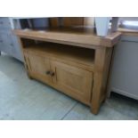 An oak corner TV cabinet with two cupboa