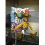 A boxed Buzz Lightyear together with a Woody doll