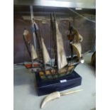 A handcrafted galleon together with a brass and molded handled letter opener