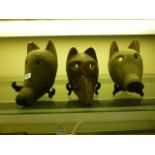 Three carved wooden masks in the form of animals