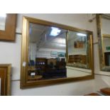 A gilt framed bevelled glass wall mirror