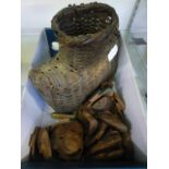 A box containing small wooden African style masks and a wicker basket