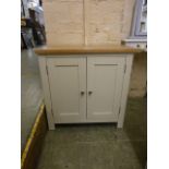 An oak topped and ivory based two door cabinet (10.