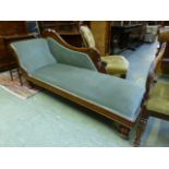 An Edwardian chaise lounge upholstered in a cut green fabric