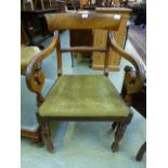 An early 19th century mahogany open arm chair with scroll arms on turned legs