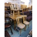 A set of four beech kitchen chairs with pierced splats