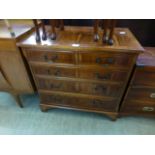 A modern yew veneered and banded chest of two short over three long drawers