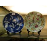 A blue and white floral decorated oriental plate together with an oriental hand painted bird and