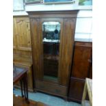 An early 20th century mahogany single door wardrobe,