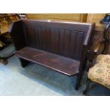 A late 19th century stained pine pew