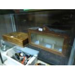 An oak lidded box together with a wooden glazed pull down front display cabinet