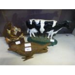 Two cast metal doorstops, one in the form of a fish, the other in the form of a cow,
