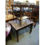 An early 20th century mahogany bed tray with collapsible legs along with two tables