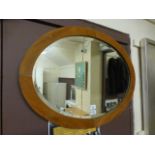A pine framed oval bevelled glass mirror