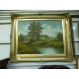 A gilt framed oil on canvas of river through countryside scene,