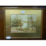 A framed and glazed watercolour of trees by river scene
