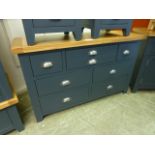 An oak topped and dark grey based sideboard with multiple drawers (23.