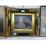 An ornate gilt and ebonised framed oleograph of kittens