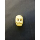 A carved bone memento mori