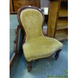 A 19th century mahogany nursing chair with button back upholstery