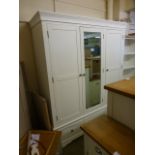An ivory triple wardrobe with drawer base (17.