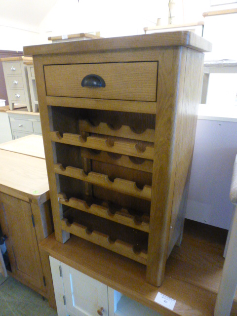 An oak wine rack with single drawer (29.