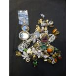 A bag of assorted costume jewellery beads, brooches etc.
