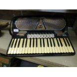 A black Capri piano accordion with hard travel case