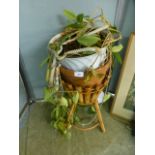 A bamboo and wicker stand containing a terracotta plant pot and a plant CONDITION