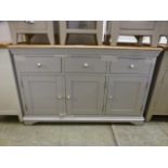 A limed oak topped grey based sideboard, three drawers over three cupboard doors (28.
